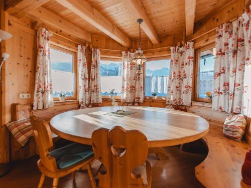 a dining room with a wooden table and chairs at Apartment Geislhof by Interhome in Bramberg am Wildkogel
