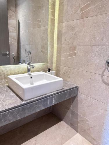 a bathroom with a white sink and a mirror at The Pyramid Escape in Cairo