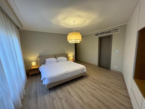 a bedroom with a white bed and two lamps at The Pyramid Escape in Cairo
