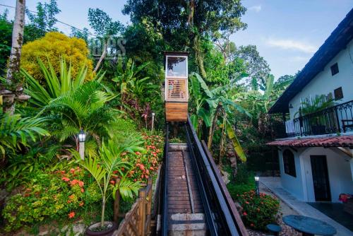a toy train going down a track in a garden at Pousada Natureza in Morro de São Paulo