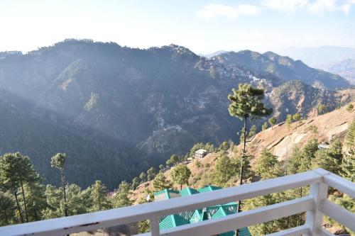 a view of the mountains from the balcony of a house at RKM Biulding Sharma B&B in Shimla
