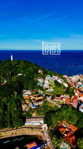 an aerial view of a town with a lighthouse at Pousada Natureza in Morro de São Paulo