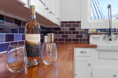 a bottle of wine and two wine glasses on a counter at The Grand on Garden in Coeur d'Alene