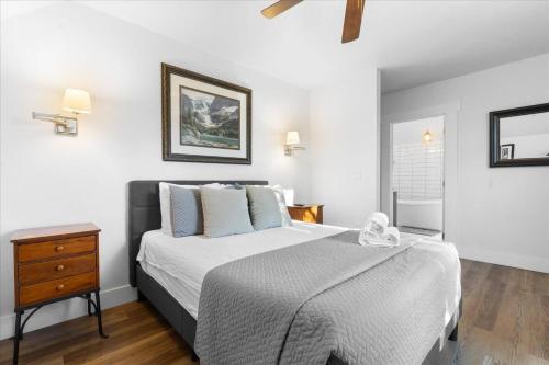 a bedroom with a large bed and a night stand at The Grand on Garden in Coeur d'Alene