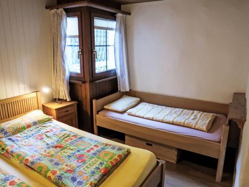 a small room with two beds and a window at Apartment Wohnung Nr-2 by Interhome in Schluein
