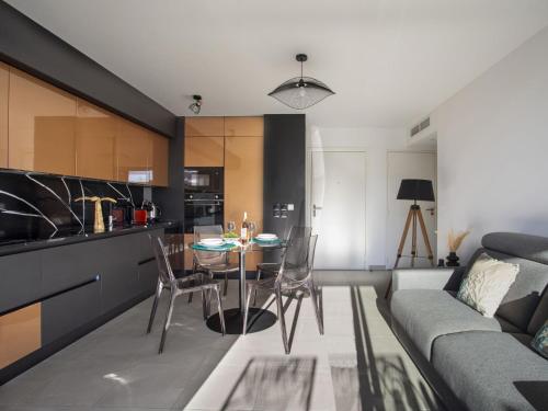 une cuisine et un salon avec une table et des chaises dans l'établissement Apartment Le Grey Pearl by Interhome, à Cagnes-sur-Mer