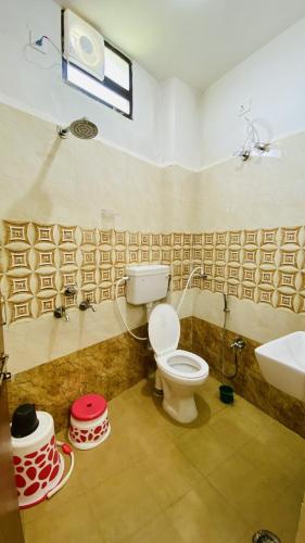 a bathroom with a toilet and a sink at Madai Resort in Māndu