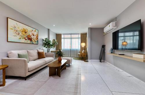 a living room with a couch and a table at AB House in Bangkok