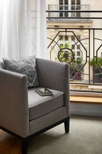 a chair sitting in front of a window at Sofitel Paris Arc De Triomphe in Paris