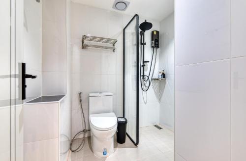 a white bathroom with a toilet and a shower at AB House in Bangkok