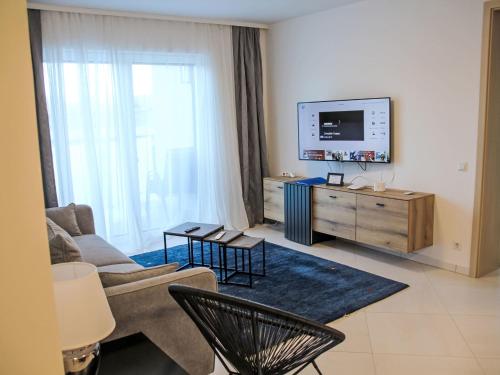 a living room with a couch and a tv in it at Apartment Sunshine view by Interhome in Sekirn