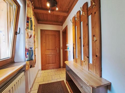 a hallway with a wooden bench and a door at Apartment Hermine by Interhome in Auffach