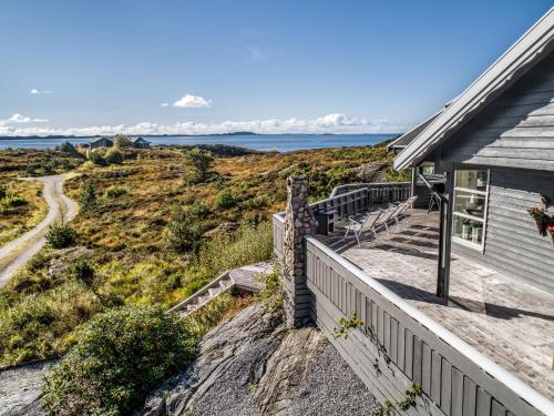 a house with a staircase leading down to the ocean at Holiday Home Sjøbuvågen by Interhome in Korssund
