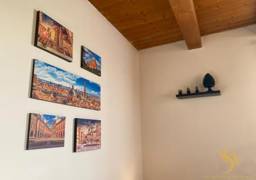 a room with many pictures on the wall at Velluto Suite Apartment in Calderara di Reno