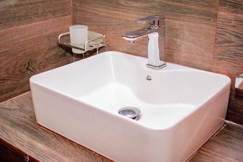 a white sink with a faucet in a bathroom at Loony Villa in Negombo