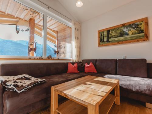 a living room with a brown couch and a table at Apartment Schoppengrub by Interhome in Mühlbach