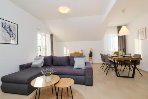 a living room with a couch and a table at Apartments Divna in Mali Lošinj