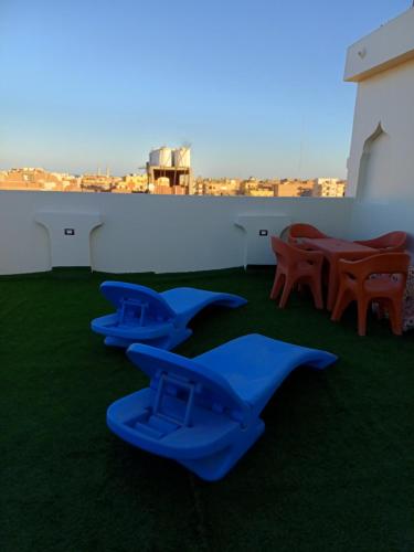 a group of blue airplanes sitting on the grass at Sunny sky in Quseir