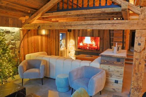 a living room with a couch and chairs and a fireplace at Chalet Jean (Coeur de Morzine) Jacuzzi & Sauna in Morzine