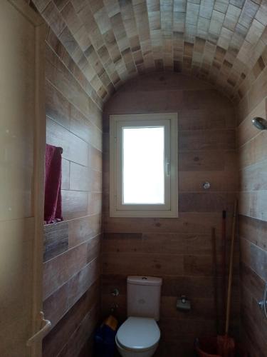a small bathroom with a toilet and a window at Sunny sky in Quseir