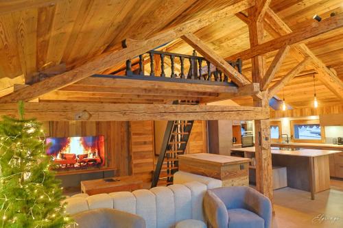 a living room with a staircase in a cabin at Chalet Jean (Coeur de Morzine) Jacuzzi & Sauna in Morzine
