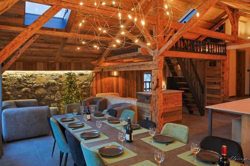 a dining room with a long table and chairs at Chalet Jean (Coeur de Morzine) Jacuzzi & Sauna in Morzine