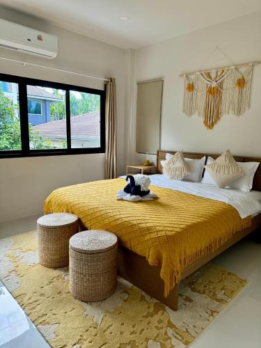 a bedroom with a large bed with a teddy bear on it at Luna villa Chaweng Samui in Nathon Bay