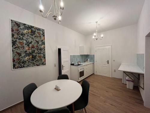 a kitchen with a table and chairs in a room at Pension Zámek Rudník in Rudník