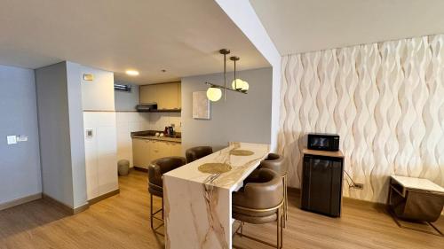 a kitchen and dining room with a table and chairs at Tequendama Suites Bogota in Bogotá