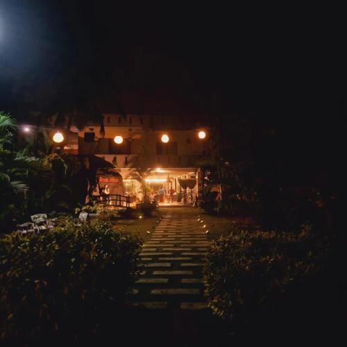 a night view of a house with lights at Dreamvillage in Dodanduwa