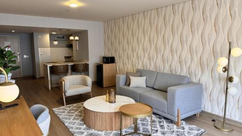 a living room with a couch and a table at Tequendama Suites Bogota in Bogotá