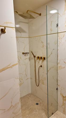 a bathroom with a shower with a glass door at Tequendama Suites Bogota in Bogotá