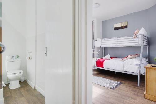 a bedroom with a bunk bed and a toilet at Azure Beach Hotel in Bournemouth