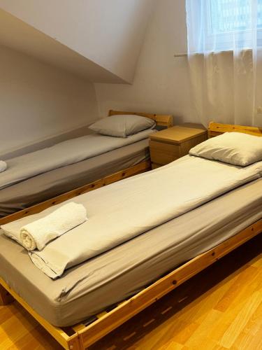two twin beds in a room with a window at ESA Home in Warsaw