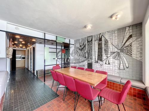 une salle à manger avec une table et des chaises rouges dans l'établissement Villa pieds dans l'eau pour 10 personnes avec port privé et rooftop à Cavalière, au Lavandou