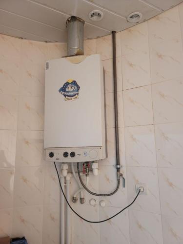 a water tank on a wall in a bathroom at Tsaghkadzor Inn Guest House in Tsaghkadzor