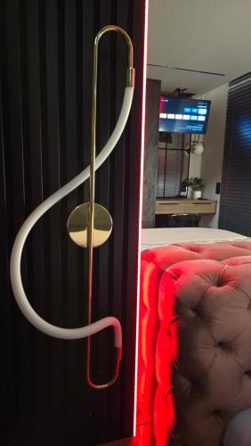a red couch next to a wall with a hanger at Apartament Dark Prestige NEW ! - dostęp 24h, PROJEKTOR , garaż podziemny , klimatyzacja , duży taras in Kielce