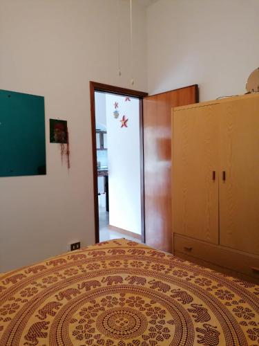 a bedroom with a large bed and a sliding glass door at Stella Marina in Tertenìa