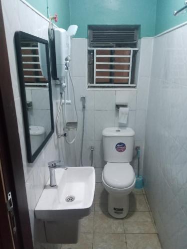 a small bathroom with a toilet and a sink at City Resort Executive Services in Seeta