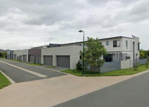 a row of houses on the side of a street at Modern Elegance Near Lakes Train Parks and Beaches in North Lakes