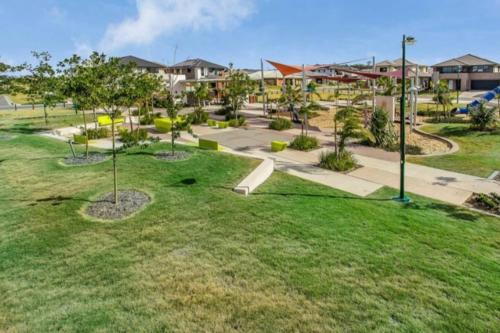 a park with a skate park with trees and a skateboard ramp at Modern Elegance Near Lakes Train Parks and Beaches in North Lakes