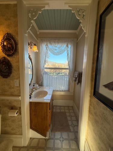 a bathroom with a sink and a window at Roseberry House Bed and Breakfast in Susanville