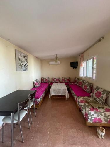 a living room with a couch and a table at Farmhouse in Kamouni in Dar Caïd Ahemd