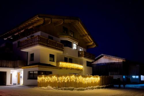 a building with a bunch of lights in front of it at Ferienwohnung am Bauernhof, Korbingerhof in Rinn