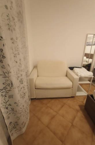 a living room with a white couch and a chair at Sea Trail in Avegno