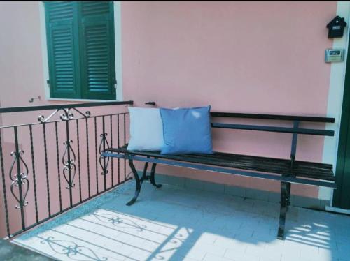 a bench with a blue pillow sitting on a fence at Sea Trail in Avegno