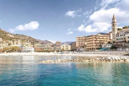 a city with a beach and buildings and birds in the water at Sea Trail in Avegno