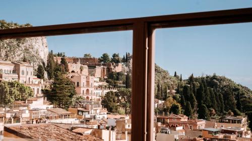 a view of a city from a window at Taormina Palazzo di Ferro in Taormina
