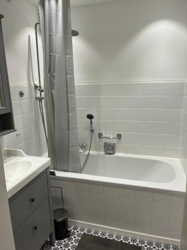 a white bathroom with a tub and a sink at Süße Marie Durlach 13 in Karlsruhe