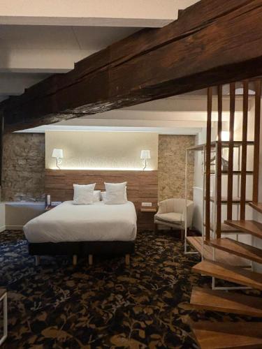 a hotel room with a bed and a staircase at Logis HOTEL DU PARC in Pont-à-Mousson